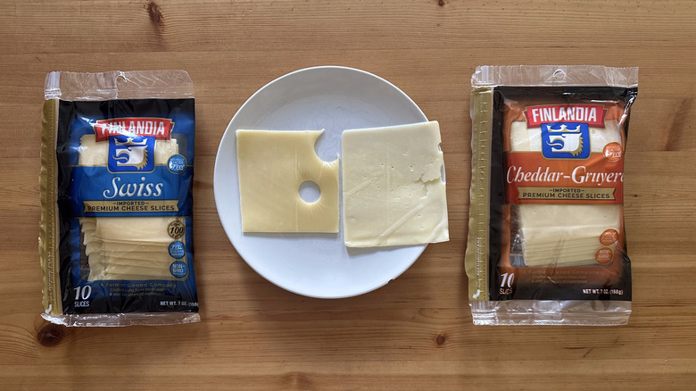 Packages of Finlandia sliced cheese on wooden table