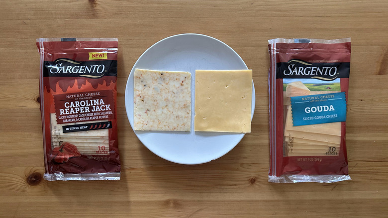 Packages of Sargento sliced cheese on wooden table