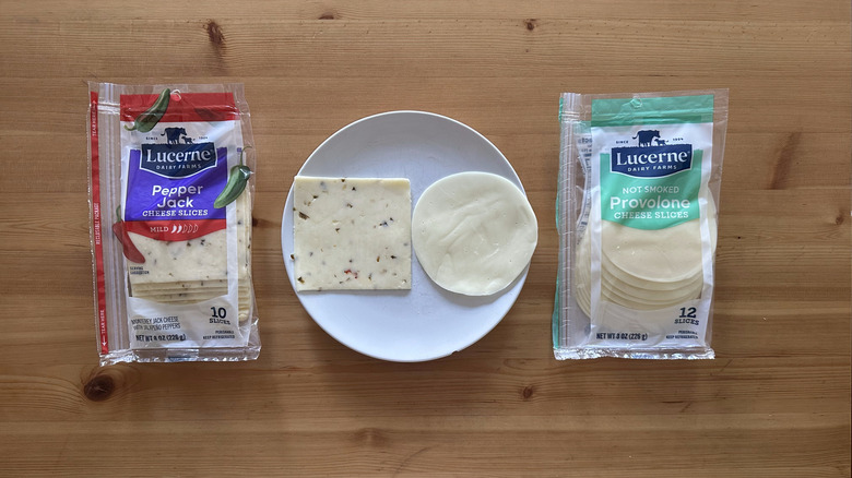 Packages of Lucerne sliced cheese on wooden table