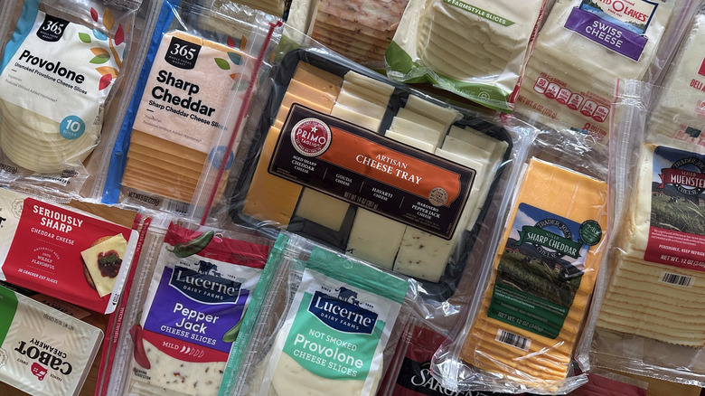 Packages of sliced cheese arranged on table