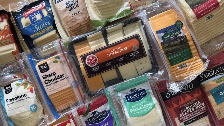 Packages of sliced cheese arranged on table