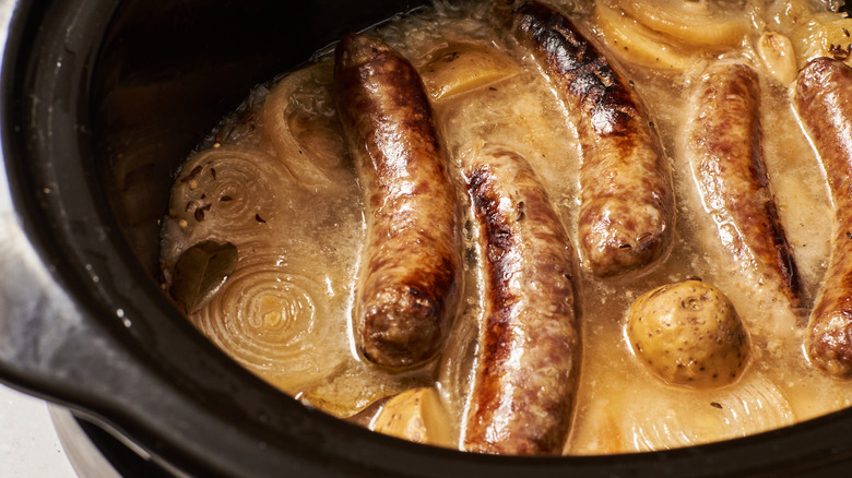 brats and onions in pot