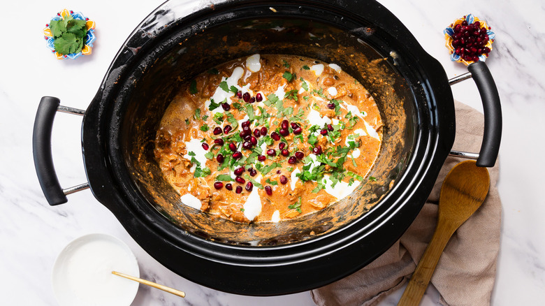 Chicken Tikka Masala with pomegranate seeds and cilantro in slow cooker