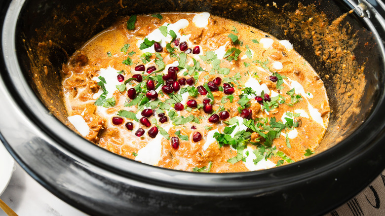 Chicken Tikka Masala with pomegranate seeds and cilantro in slow cooker