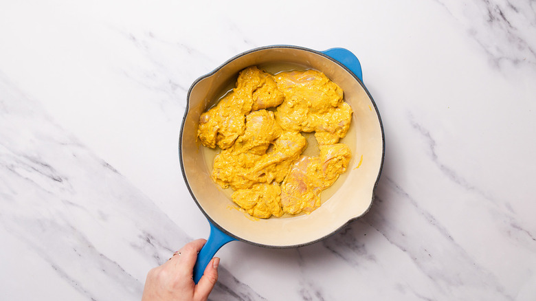 Chicken sauteing in pan