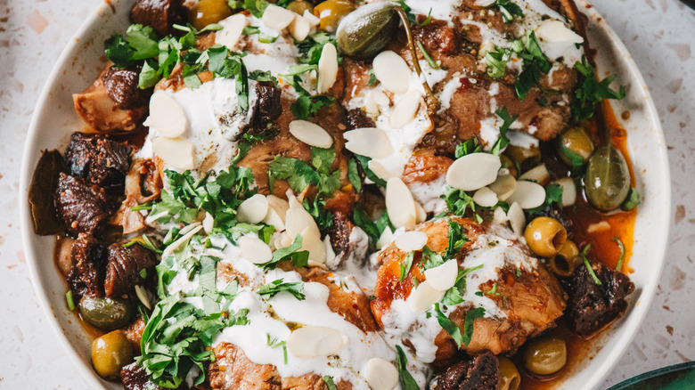 Large plate with bone-in chicken thighs with olives, figs, yogurt and cilantro