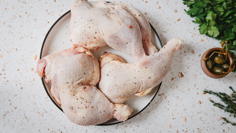 Seasoned chicken with salt and pepper on plate