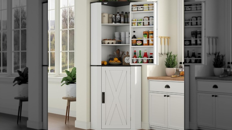 The Gyfimoie corner pantry in a kitchen corner nook with its top door open revealing kitchen staples inside