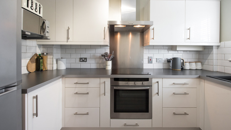small white kitchen with gray countertops