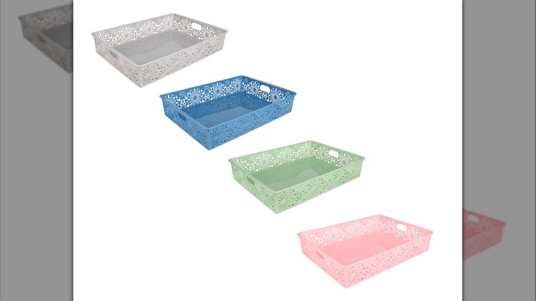 The daisy design laser-cut plastic letter baskets in gray, blue, green, and pink on a white background