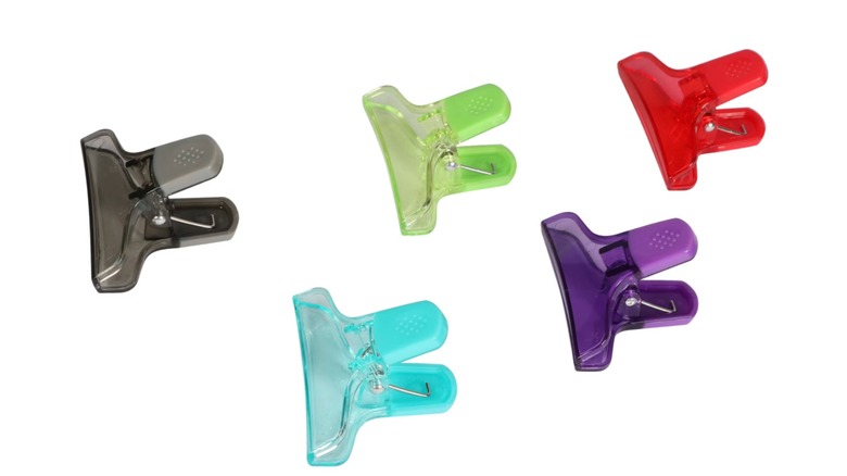Five multi-colored chip clips on a white background