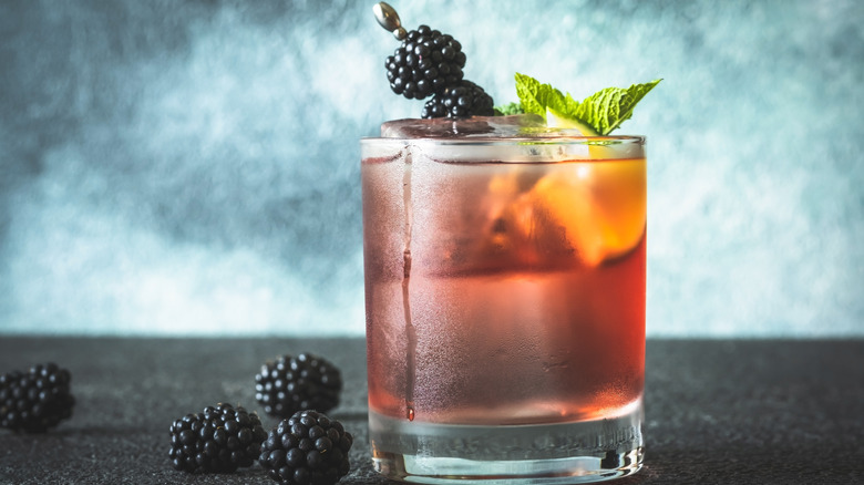 A blackberry Bourbon Smash with mint garnish
