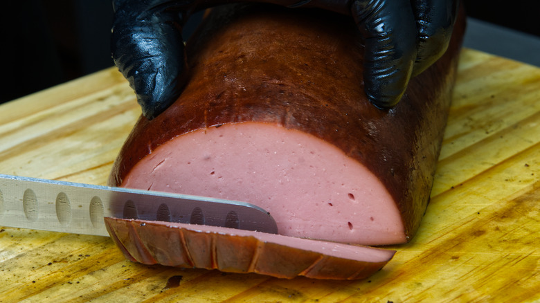 Slicing smoked bologna.