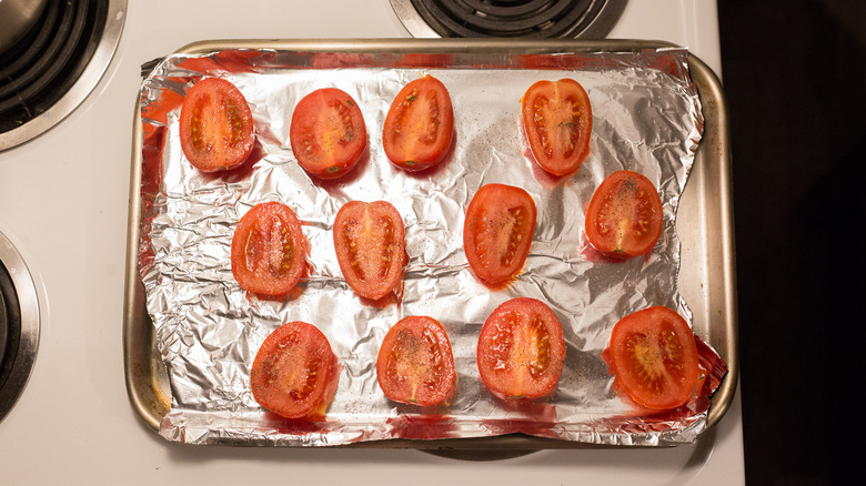 halved tomatoes on baking sheet