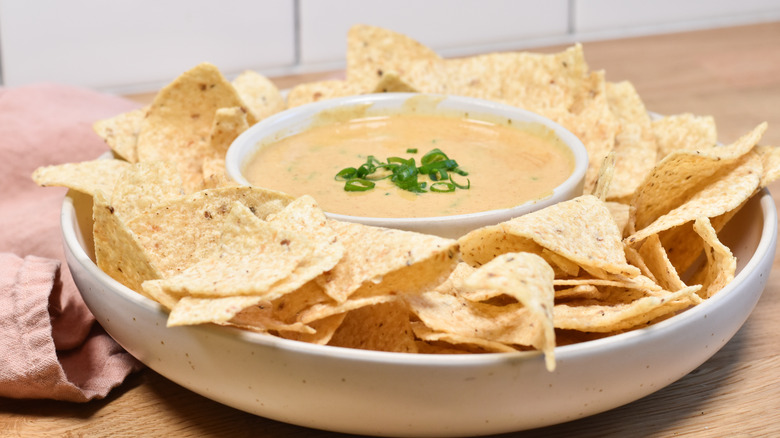 bowl of cheese queso dip with tortilla chips