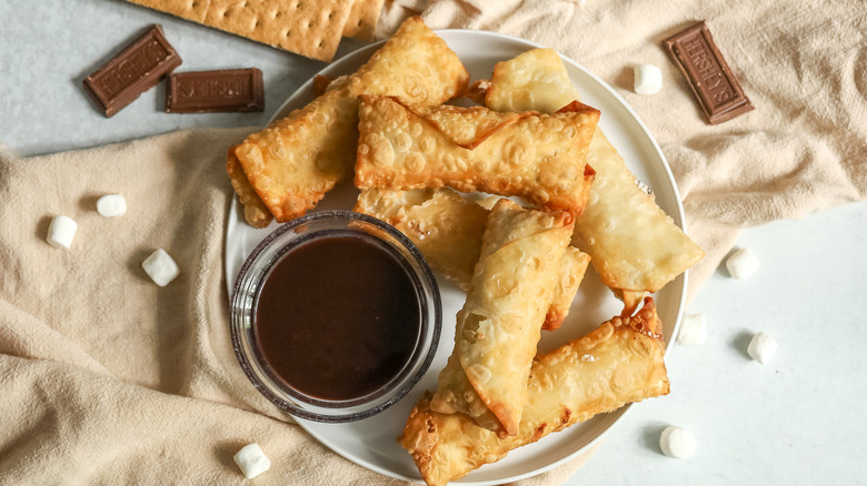 egg rolls with bowl of chocolate sauce