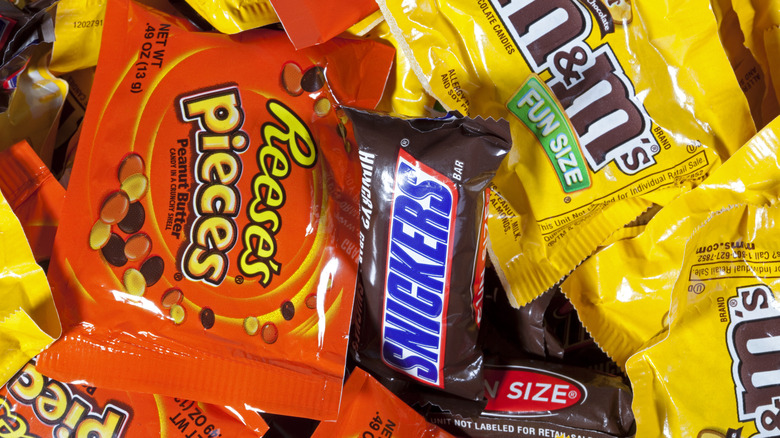 various packets of candy including M&Ms, Reese's pieces, Snickers
