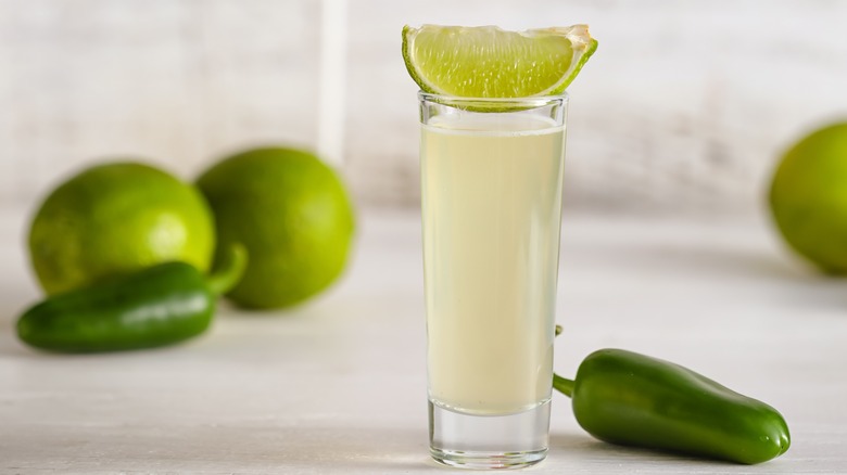 Tequila shot with limes and jalapenos