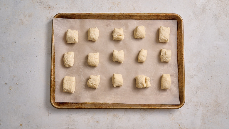 pretzel dough pieces on a sheet tray