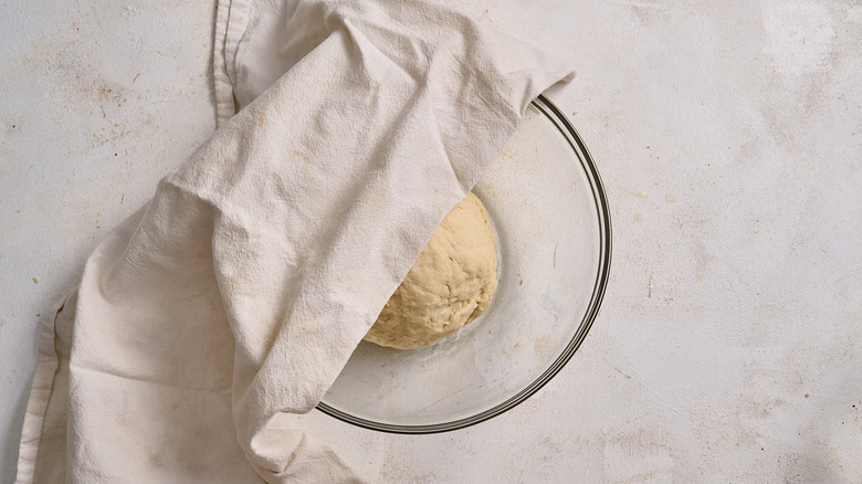 covering dough with a towel