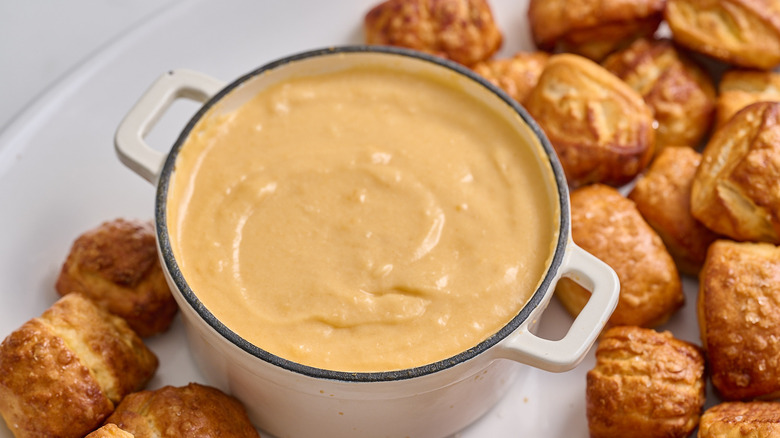 beer cheese dip in a container on a platter