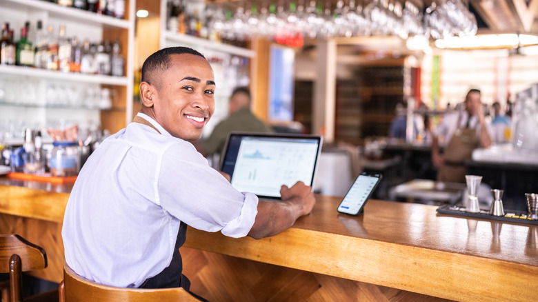 Person using a laptop at a bar