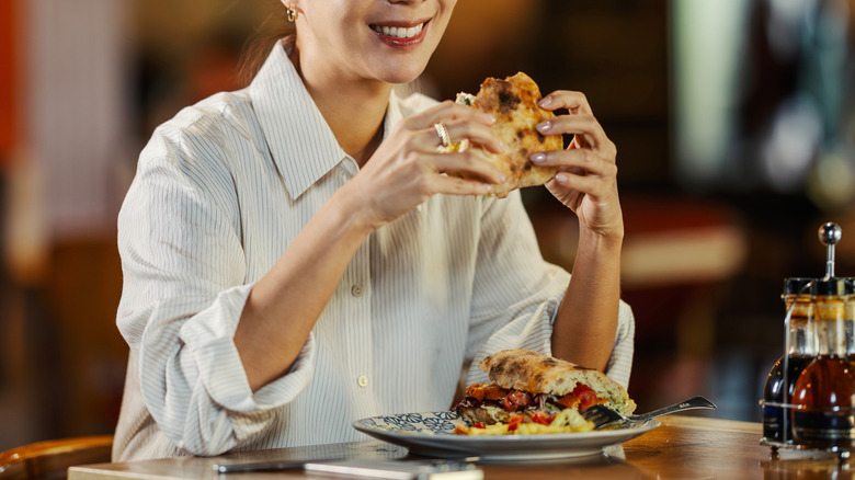 person smiling while dining solo