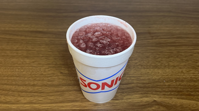 Sonic Hotumn Harvest Berry made with Sprite drink in to-go cup.