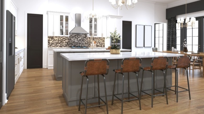 modern kitchen with chandlier hanging over kitchen islands and table