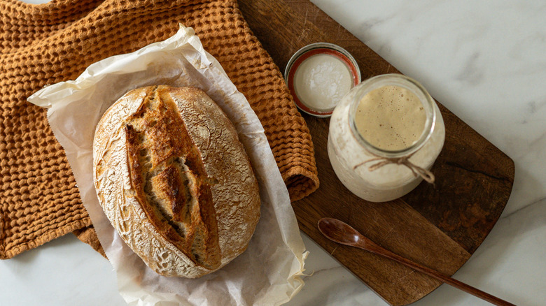 sourdough starter and loaf of bread