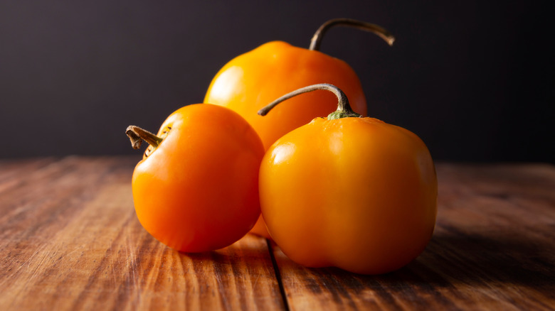 rocoto peppers on wooden table