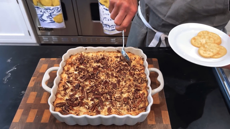 Hand scooping creamy Vidalia onion dip