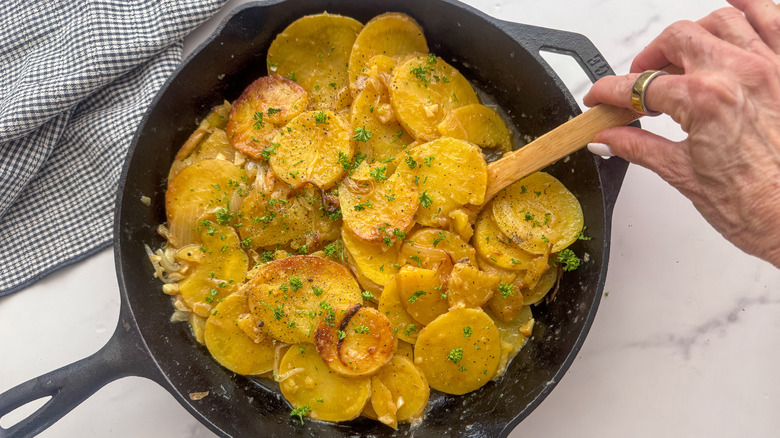 Smothered potatoes in cast iron skillet