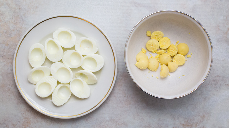 separated hard-boiled eggs on table