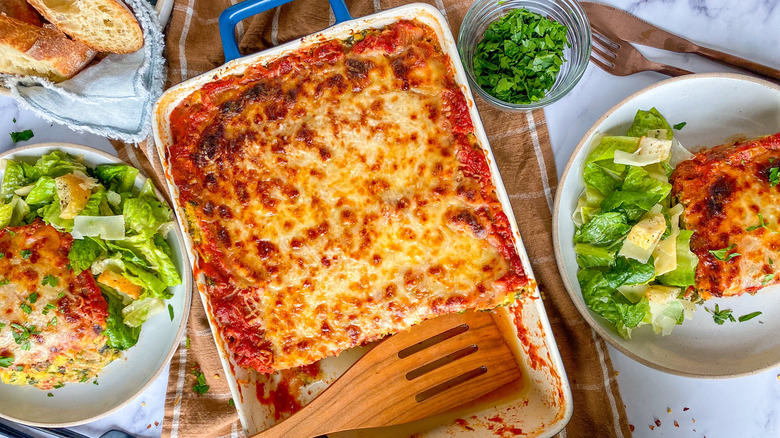 lasagna in baking dish, slices
