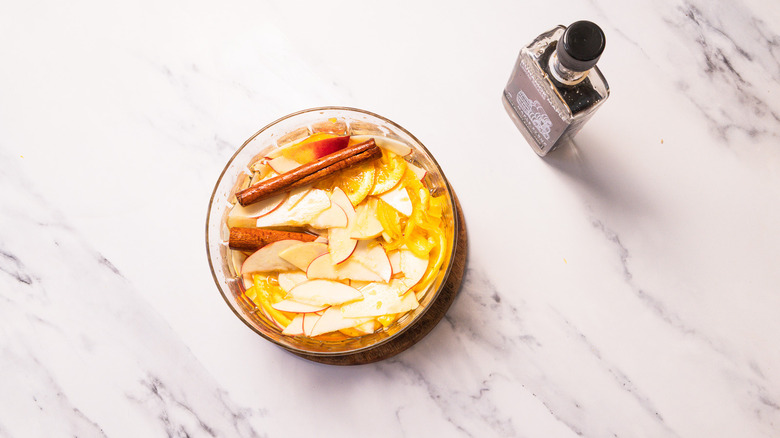 Apple sangria base in bowl besides maple syrup