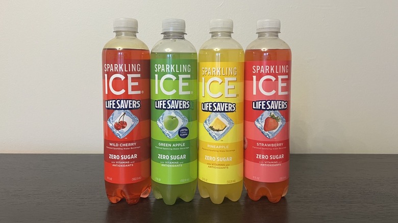 Four different Sparkling Ice Life Savers flavors in bottles.