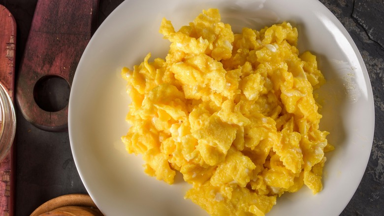 Fluffy scrambled eggs on a white plate