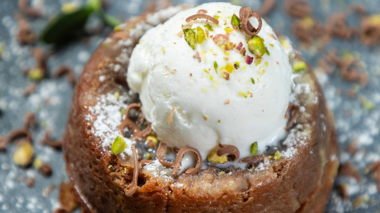 Lava cake topped with a scoop of vanilla ice cream.