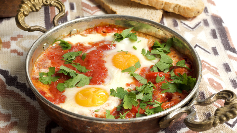 fried eggs in skillet with harissa paste