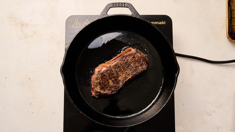 Searing steak in a skillet