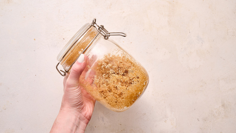shaking jar of bourbon sugar