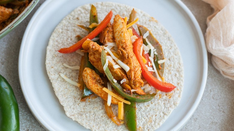 chicken and vegetables on tortilla