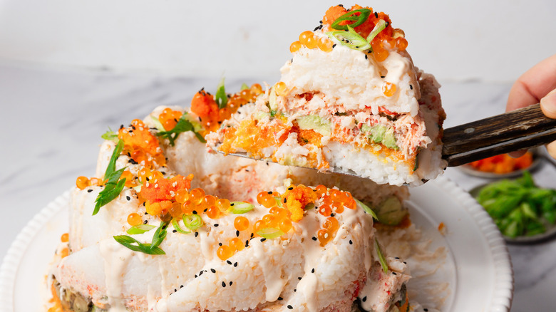 Hand lifting a piece of sushi bundt cake with a cake lift.