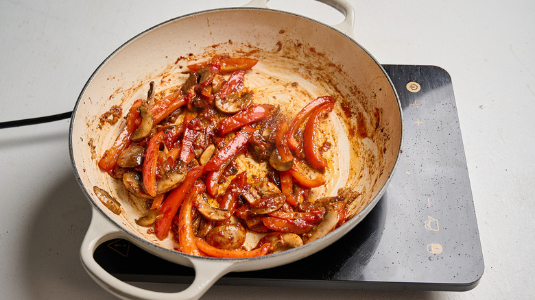stirring gochujang and tomato paste into skillet