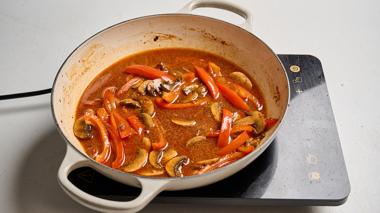 simmering broth in a skillet