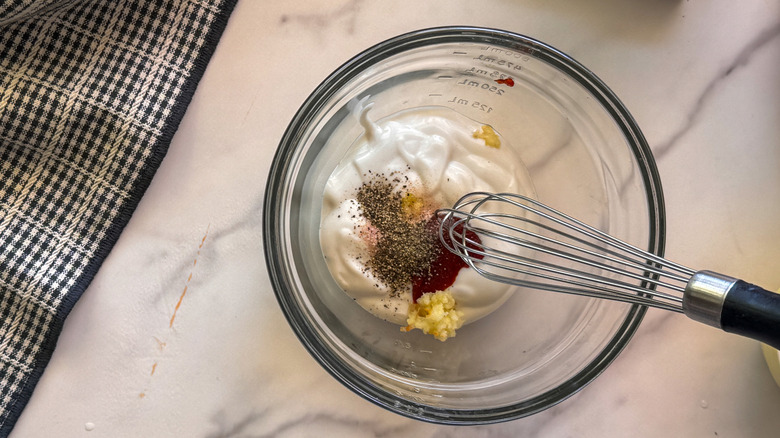 whisk in bowl of sauce