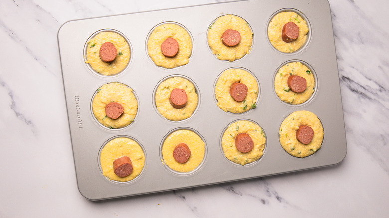 Corn dog muffins in muffin tin.