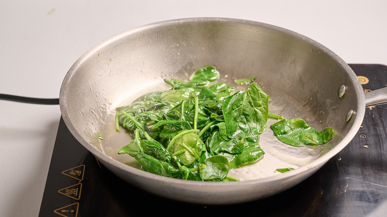 cooking spinach in a skillet