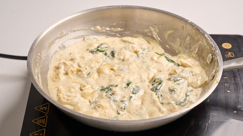 melting cheeses into mixture in skillet